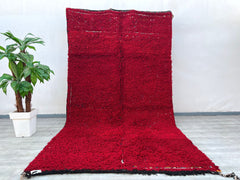 Elevate your home with this stunning handmade Moroccan Boujad rug, featuring a striking red and black tribal motif. Measuring 7x9 ft, this vintage wool rug is crafted using traditional Berber techniques, ensuring a soft yet durable texture. The bold geometric patterns and faded hues create a lived-in, bohemian aesthetic, perfect for eclectic or minimalist interiors. Its versatile design complements both modern and rustic spaces, adding warmth and texture. Whether used as an area rug or wall hanging, this pi