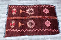 Transform narrow spaces with this long vintage Moroccan runner rug, measuring 3x11 ft. Handwoven by skilled artisans, this piece features a striking diamond-patterned design in rich reds, pinks, and neutrals, accented by traditional Berber symbolism. The wool construction ensures softness underfoot, while the flat-weave kilim style makes it low-profile for high-traffic areas. Ideal for hallways, entryways, or layered beside beds, this rug adds a nomadic, bohemian flair. Each knot tells a story, with slight