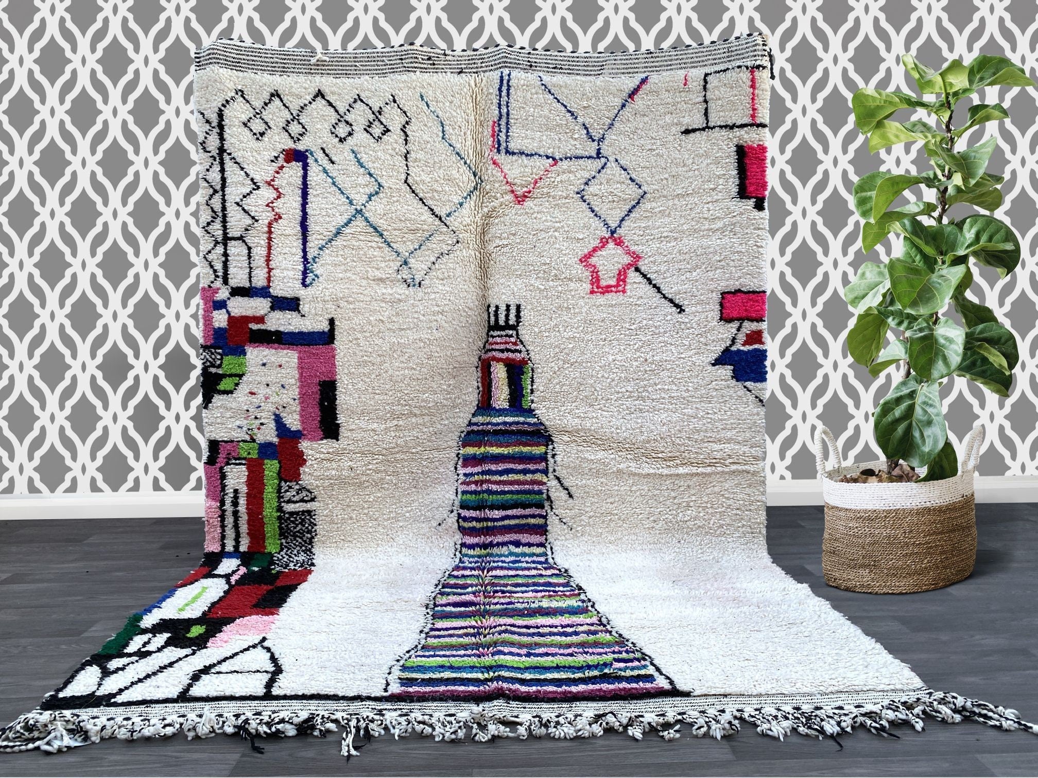 Elevate your home with an authentic Azilal Berber rug, a hand-knotted Moroccan masterpiece featuring bold geometric patterns and a mix of vivid colors. These vintage-inspired rugs are handmade by Berber women using age-old techniques, ensuring each piece is unique. The high-quality wool construction offers both durability and plush comfort, making it perfect for high-traffic areas. Whether you prefer a modern abstract design or a traditional tribal motif, this Moroccan area rug adds a touch of global elegan