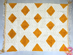 Bring the artisanal beauty of Morocco into your home with this authentic Beni Ourain rug, handcrafted from premium, natural wool. The minimalist tribal patterns and neutral tones make it a versatile statement piece for modern, boho, or farmhouse decor. Available in custom sizes (6x6 ft, 7x10 ft, or bespoke dimensions), this rug is ultra-soft, hypoallergenic, and long-lasting. Ideal for high-traffic areas, it resists shedding while maintaining a luxurious, high-pile texture. Free shipping worldwide ensures a