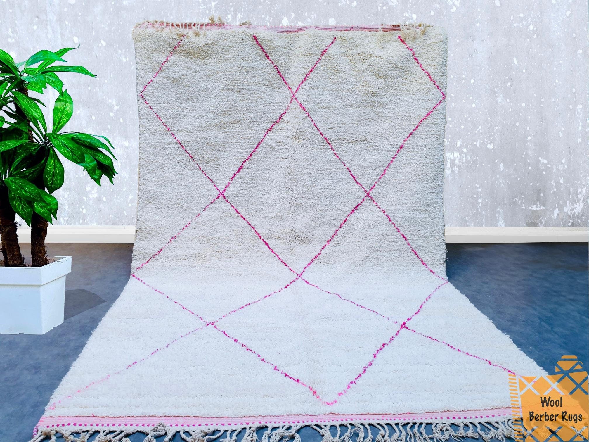 Bring the timeless beauty of Moroccan craftsmanship into your home with this authentic Beni Ourain-style rug. Handmade from the finest sheep wool, this plush carpet features a soft green hue with traditional Berber motifs, perfect for creating a cozy, inviting atmosphere. Ideal for living rooms, nurseries, or bohemian-inspired spaces, this rug offers both comfort and artistic flair. The customizable design allows you to choose the perfect size and shade to match your decor. With its organic texture and arti