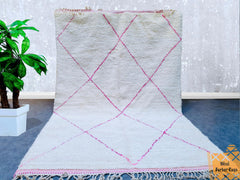 Bring the timeless beauty of Moroccan craftsmanship into your home with this authentic Beni Ourain-style rug. Handmade from the finest sheep wool, this plush carpet features a soft green hue with traditional Berber motifs, perfect for creating a cozy, inviting atmosphere. Ideal for living rooms, nurseries, or bohemian-inspired spaces, this rug offers both comfort and artistic flair. The customizable design allows you to choose the perfect size and shade to match your decor. With its organic texture and arti