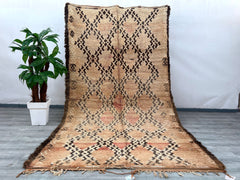 Enhance your space with this stunning Boujad Moroccan rug, a true testament to traditional craftsmanship. Handmade using premium wool, this rug features a rich, faded design with intricate tribal motifs, offering a perfect balance of vintage charm and modern appeal. The distressed, overdyed finish gives it a one-of-a-kind look, while the soft, neutral tones effortlessly complement any décor. Whether placed in a living room, dining area, or bedroom, this handwoven Berber carpet adds warmth, texture, and cult