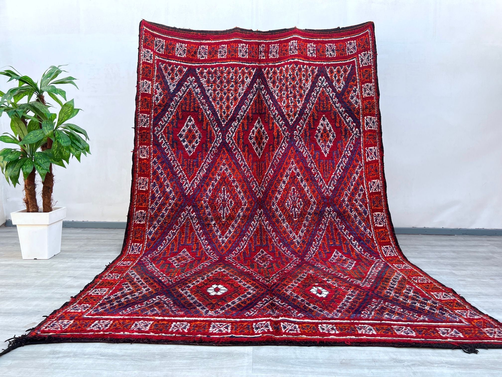 A beautifully crafted Afghan tribal rug, this piece showcases bold geometric motifs and vibrant natural dyes, reflecting centuries-old weaving traditions. Made from high-quality wool, the rug is durable yet soft underfoot, ideal for high-traffic areas. The intricate patterns and rich red, orange, and dark hues add warmth and character to any interior, from modern minimalist spaces to eclectic boho decor. Hand-knotted with precision, this vintage-inspired rug carries the essence of nomadic artistry, making i