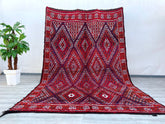 A beautifully crafted Afghan tribal rug, this piece showcases bold geometric motifs and vibrant natural dyes, reflecting centuries-old weaving traditions. Made from high-quality wool, the rug is durable yet soft underfoot, ideal for high-traffic areas. The intricate patterns and rich red, orange, and dark hues add warmth and character to any interior, from modern minimalist spaces to eclectic boho decor. Hand-knotted with precision, this vintage-inspired rug carries the essence of nomadic artistry, making i