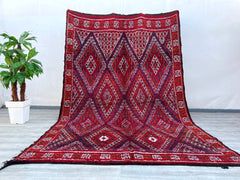 A beautifully crafted Afghan tribal rug, this piece showcases bold geometric motifs and vibrant natural dyes, reflecting centuries-old weaving traditions. Made from high-quality wool, the rug is durable yet soft underfoot, ideal for high-traffic areas. The intricate patterns and rich red, orange, and dark hues add warmth and character to any interior, from modern minimalist spaces to eclectic boho decor. Hand-knotted with precision, this vintage-inspired rug carries the essence of nomadic artistry, making i
