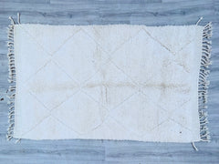 Discover the beauty of authentic handmade Moroccan Beni Ourain rugs, crafted by skilled Berber artisans using premium wool. These luxurious rugs feature a soft, high-pile texture with traditional geometric patterns, adding warmth and elegance to any space. Perfect for living rooms, bedrooms, or hallways, each rug is a unique piece of art, blending bohemian charm with minimalist design. The natural wool fibers provide durability and comfort, making them ideal for cozy interiors. Whether you prefer classic iv