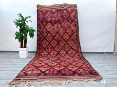 Elevate your home with this handmade Moroccan rug, a 6x13 ft masterpiece crafted in the traditional Berber style. Made from organic sheep wool, this vintage area rug showcases intricate tribal patterns and a soft, high-pile texture, offering both comfort and durability. The neutral color palette effortlessly complements any interior, from minimalist to bohemian. Each rug is one-of-a-kind, with slight variations that highlight its artisan craftsmanship. Perfect for living rooms, dining areas, or bedrooms, th