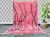 Elevate your home decor with this handmade Moroccan Azilal rug, a stunning Berber wool carpet featuring vibrant colors and geometric motifs. Woven by skilled artisans, this tribal-inspired rug combines soft textures with durable craftsmanship, making it perfect for high-traffic areas. The bohemian design adds an exotic touch to any room, whether placed in a living room, entryway, or bedroom. Each piece tells a story through its unique patterns and natural wool fibers, ensuring no two rugs are alike. A timel