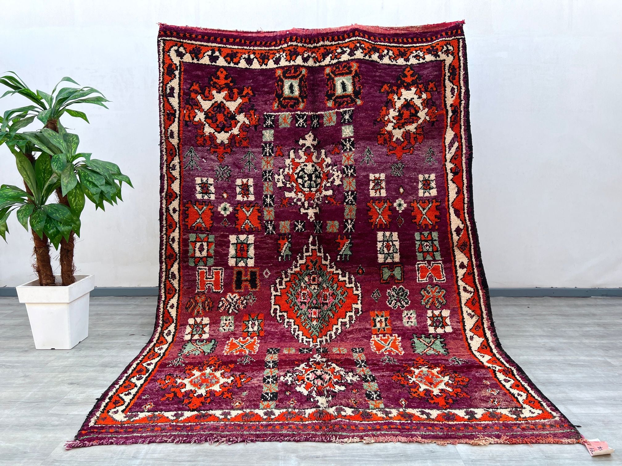 Discover the timeless beauty of this vintage Moroccan Berber rug, a handmade wool masterpiece featuring intricate tribal patterns and natural dyes. With dimensions of 7x14 feet, this oversized area rug is ideal for open-concept spaces, dining rooms, or cozy lounges. The Boujaad design reflects Moroccan craftsmanship, blending vintage aesthetics with durable, soft wool for long-lasting comfort. Each rug tells a story through its unique geometric motifs, making it a conversation-starting centerpiece. Whether