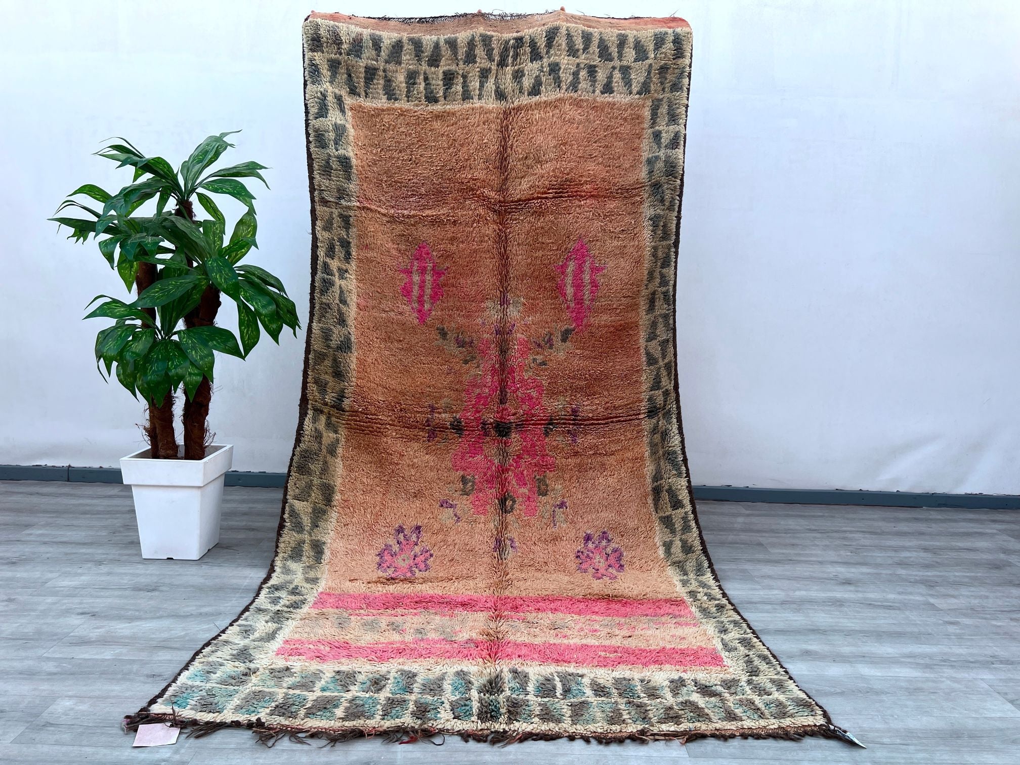 Elevate your home with this authentic vintage Berber rug, a stunning tribal bohemian floor decor piece. Handwoven by skilled artisans, this Moroccan wool rug features bold geometric motifs and a soft, plush texture, making it both stylish and comfortable. The faded vintage hues add a rustic charm, perfect for boho-chic, farmhouse, or eclectic interiors. As a durable handmade carpet, it withstands daily use while maintaining its artistic appeal. Whether used as a statement area rug or a cozy accent, this one