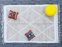 Elevate your home with this stunning bohemian Azilal rug, hand-knotted using premium wool for a plush, cozy feel. Featuring vibrant tribal motifs and a unique distressed look, this rug adds character and charm to any room. Whether placed in a modern, rustic, or eclectic setting, its artistic patterns create a focal point that enhances your decor. The natural wool fibers provide durability and comfort underfoot, making it ideal for high-traffic areas. A beautiful blend of tradition and contemporary style, th