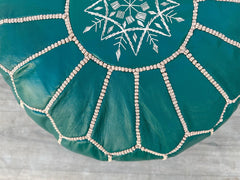 Bring global-inspired style into your home with a hand-embroidered Moroccan leather pouf. Each piece is handcrafted in Marrakech using vegetable-tanned leather and filled with eco-friendly recycled foam. The intricate geometric stitching and rich earthy tones make it a standout decor piece. Use it as a floor seat, footrest, or side table in your living room, bedroom, or patio. These authentic leather ottomans are fair-trade certified, supporting traditional craftsmanship. Available in unstuffed or pre-fille