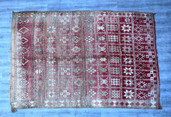 Infuse your home with global boho flair using this handmade Moroccan Kilim rug. Woven with premium wool in a traditional tribal design, this rug features vibrant red and earthy tones, intricate embroidery, and a distressed vintage finish. Ideal for layering in eclectic spaces, as a statement floor piece, or as a wall hanging, this authentic Berber kilim adds warmth and texture to any décor. The durable, hand-knotted construction ensures both beauty and resilience, making it a cherished addition to living ro