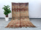 Elevate your interior with this bohemian vintage Moroccan rug, a true testament to artisanal weaving traditions. Featuring a distressed tribal design, this handmade wool carpet showcases a harmonious mix of deep reds, warm oranges, and neutral hues, creating a striking focal point. The Berber-inspired motifs add cultural depth, while the plush, high-pile texture ensures comfort underfoot. Ideal for eclectic, boho-chic, or minimalist spaces, this oriental area rug brings character and coziness to bedrooms, l