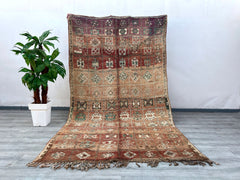 Elevate your interior with this bohemian vintage Moroccan rug, a true testament to artisanal weaving traditions. Featuring a distressed tribal design, this handmade wool carpet showcases a harmonious mix of deep reds, warm oranges, and neutral hues, creating a striking focal point. The Berber-inspired motifs add cultural depth, while the plush, high-pile texture ensures comfort underfoot. Ideal for eclectic, boho-chic, or minimalist spaces, this oriental area rug brings character and coziness to bedrooms, l