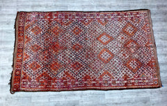 Transform your home with this beautiful boho-style vintage Moroccan rug, handwoven by traditional artisans. The rug’s distressed texture and muted color palette bring a rustic yet sophisticated charm to any room. Its intricate geometric patterns and organic imperfections highlight the authenticity of handmade craftsmanship. Perfect for layering or as a standalone statement piece, this wool rug adds depth and warmth to living rooms, bedrooms, or reading nooks. Whether you’re aiming for a bohemian, minimalist