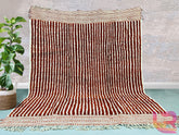 Discover the beauty of traditional craftsmanship with this hand-knotted Berber rug, made from 100% natural wool. Inspired by the timeless Beni Ourain designs, this rug features a stunning peach and cream color palette with intricate geometric motifs. The plush, high-pile texture provides unmatched softness, making it ideal for cozy spaces. Each piece is uniquely handmade, ensuring no two rugs are alike. Whether used as an area rug, bedroom accent, or boho-chic decor, this Moroccan wool rug adds warmth and s