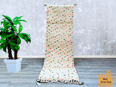 Add a touch of North African heritage with a handmade Moroccan runner rug, crafted in the traditional Beni Ourain or Azilal style. This bespoke hallway carpet is woven from 100% pure wool, offering a plush, durable surface underfoot. Choose from neutral tones, vibrant colors, or playful polka dots to match your décor. Each custom Berber runner is one-of-a-kind, featuring tribal motifs and organic imperfections that enhance its rustic charm. Whether used in entryways, kitchens, or bedrooms, this authentic Mo