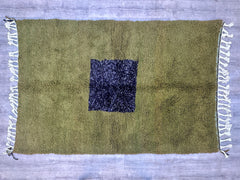 Transform your space with this beautifully handcrafted Moroccan rug, featuring a captivating green geometric motif. Each piece is woven with care, ensuring a high-quality, durable wool carpet that feels soft underfoot. The tribal-inspired design adds an exotic yet elegant touch, making it a versatile choice for modern, rustic, or eclectic interiors. Whether used as a statement piece or a cozy accent, this authentic Berber rug brings warmth and artistry to your home. Available in custom dimensions for a perf