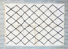 Designed for those who love understated elegance, this custom Moroccan rug combines minimalist aesthetics with authentic Berber artistry. Handwoven from premium wool, it features a clean, geometric pattern in soft neutral tones, creating a serene yet sophisticated vibe. The plush, high-pile texture adds warmth and comfort, making it perfect for cozy spaces. Ideal for modern, Scandinavian, or eclectic interiors, this rug effortlessly ties together furniture and decor. Each piece is individually crafted, ensu