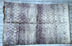 Transform your interiors with this handmade vintage Moroccan rug, featuring a beautifully faded, distressed pattern that exudes boho sophistication. Woven by artisans using natural wool, this rug boasts a plush, durable texture with a unique overdyed finish, ensuring no two pieces are alike. The tribal-inspired motifs and neutral tones make it versatile for various décor styles, from bohemian to minimalist. Perfect as a statement area rug, this authentic Berber carpet brings warmth, history, and artistic fl