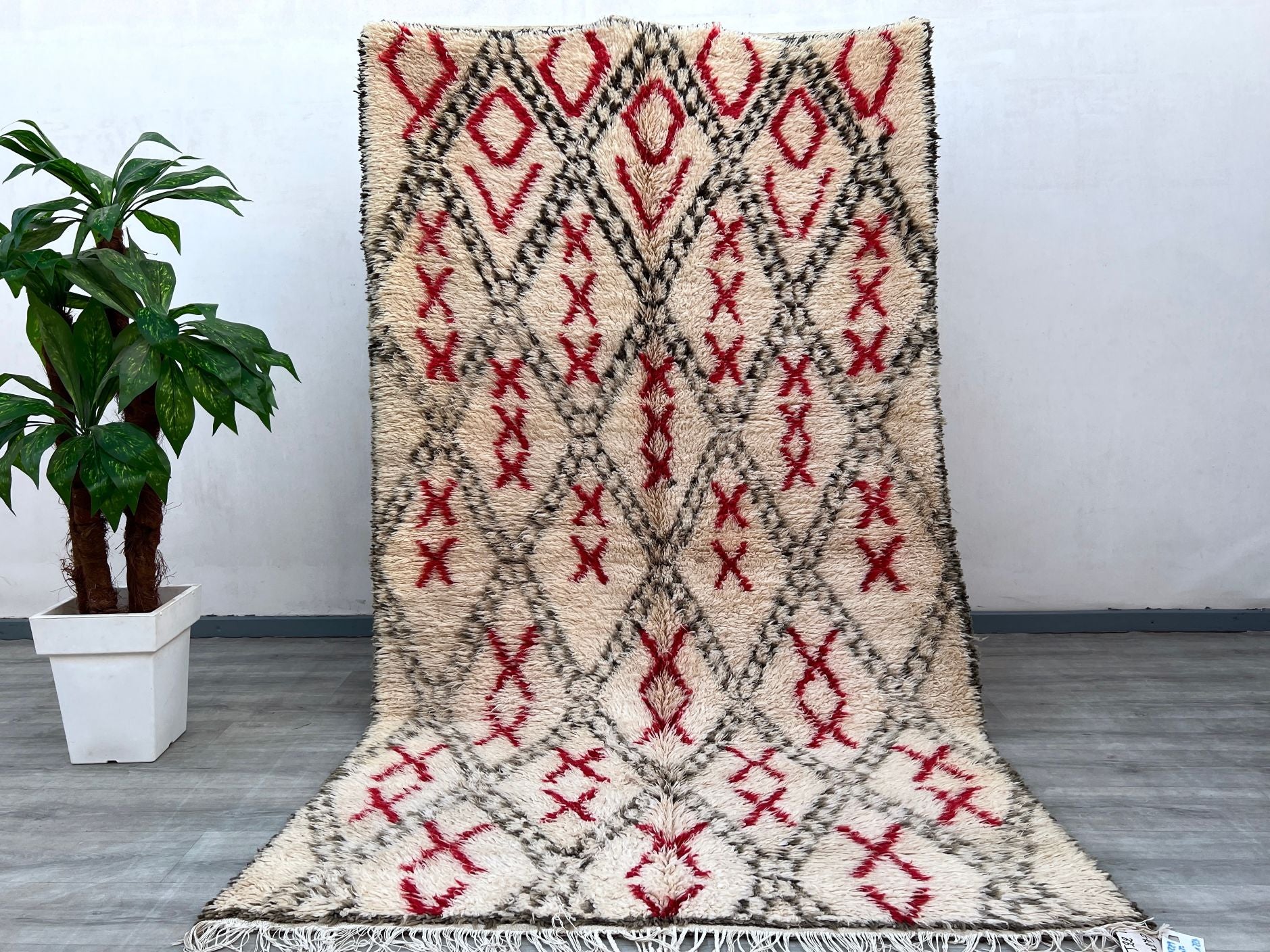 Elevate your décor with this breathtaking vintage Boujad rug, meticulously handcrafted in Morocco using age-old weaving techniques. The rich, earthy tones and tribal motifs reflect the artistry of Berber culture, making it a true collector’s item. Made from premium wool, this 5x9 ft rug offers durability and softness underfoot, perfect for high-traffic areas. Its distressed, lived-in look adds rustic charm, blending seamlessly with modern, bohemian, or traditional interiors. A versatile statement piece, it