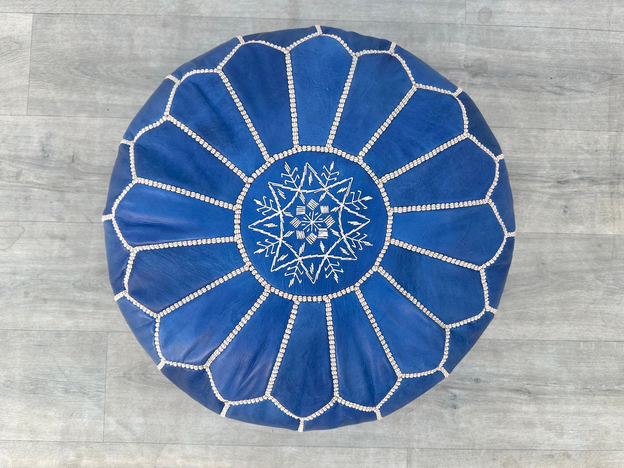 Elevate your living space with an authentic Moroccan leather pouf, hand-stitched by skilled artisans using premium goat or buffalo leather. These round or square ottomans feature intricate embroidery, vegetable-tanned dyes, and eco-friendly fillings, blending durability with boho-chic flair. Perfect as a footrest, extra seating, or decorative accent, each pouf is a unique masterpiece. Available stuffed or unstuffed, in rich browns, blacks, and vibrant hues. Free shipping worldwide. Shop now for luxury leath