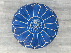 Elevate your living space with an authentic Moroccan leather pouf, hand-stitched by skilled artisans using premium goat or buffalo leather. These round or square ottomans feature intricate embroidery, vegetable-tanned dyes, and eco-friendly fillings, blending durability with boho-chic flair. Perfect as a footrest, extra seating, or decorative accent, each pouf is a unique masterpiece. Available stuffed or unstuffed, in rich browns, blacks, and vibrant hues. Free shipping worldwide. Shop now for luxury leath