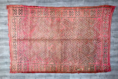 Discover the charm of Moroccan heritage with this handmade Berber rug, a vintage tribal kilim featuring geometric patterns and a distressed, lived-in look. Woven by skilled artisans, this wool rug showcases the authentic craftsmanship of North African textiles, perfect for adding a global boho touch to your home. Ideal for layering over hardwood floors or low-pile carpets, its versatile design complements Scandinavian, rustic, or eclectic styles. The natural variations in dye and weave ensure a truly unique