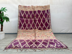 Discover the beauty of this handmade boho rug, a vintage wool carpet featuring a mesmerizing blend of purple, pink, and earthy tones. Designed with abstract patterns, this authentic Berber rug is a testament to artisanal craftsmanship, offering both durability and timeless appeal. Perfect for boho home decor, this handwoven wool rug adds texture and warmth to any space. Its vintage abstract carpet design complements mid-century, eclectic, or minimalist interiors, making it a versatile statement piece. Each
