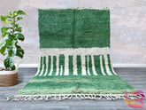 Enhance your space with this exquisite handmade Moroccan wool rug, crafted in the traditional Beni Ourain style. Featuring a soft green geometric pattern, this Berber carpet is woven by skilled artisans using natural wool for a durable yet plush texture. The abstract tribal design adds a bohemian charm to any room, making it perfect for modern, boho, or minimalist interiors. Whether placed in the living room, bedroom, or hallway, this authentic Moroccan rug brings warmth and cultural elegance to your home.