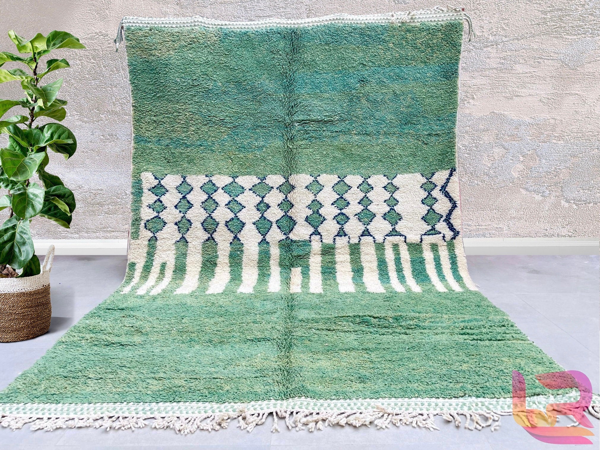 Elevate your living space with a handmade green Moroccan rug, featuring authentic Berber and Beni Ourain designs. These bohemian rugs are crafted from 100% natural wool, offering a soft, luxurious feel underfoot. Perfect for living rooms, bedrooms, or hallways, these Moroccan area rugs bring warmth and texture with their abstract patterns and tribal motifs. The green and blue hues blend seamlessly into modern, boho, or minimalist interiors. Each hand-knotted rug is unique, showcasing traditional craftsmansh