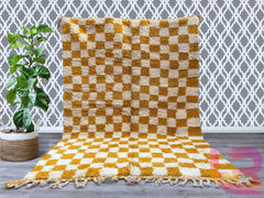 Elevate your space with a handmade Moroccan checkered rug, crafted from premium wool and cotton for durability and softness. Featuring a classic checkerboard pattern, this rug comes in versatile colors like white, curry, beige, and orange, blending seamlessly with boho, modern, or minimalist décor. Each Beni Ourain-inspired rug is customizable, offering unique textures and artisanal charm. Perfect for living rooms, bedrooms, or hallways, this Berber rug adds warmth and character to any home. Whether you pre