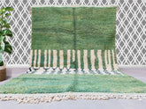 Bring timeless elegance to your home with this handmade Moroccan green rug, crafted by skilled artisans using traditional Berber techniques. Woven from genuine wool, this authentic Moroccan rug features intricate geometric patterns and a soft, plush texture, perfect for adding warmth and style to any space. The hand-knotted design ensures durability, while the natural dyes create a rich, earthy green hue that complements both modern and bohemian interiors. Ideal as a living room rug, bedroom accent, or hall