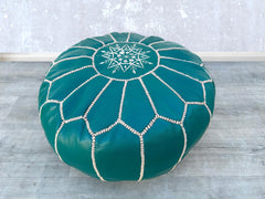 Bring authentic Moroccan craftsmanship into your home with our handmade leather pouf. Each piece is meticulously crafted by skilled artisans using premium goat leather, vegetable-tanned for durability. The intricate hand-stitched embroidery adds a bohemian touch, perfect for living rooms, bedrooms, or reading nooks. Use it as a footrest, extra seating, or decorative accent. Available in brown, tan, and deep orange, this pouf is filled with eco-friendly recycled foam for comfort. Free shipping & wholesale op