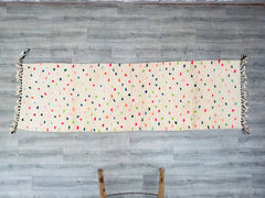 Elevate your space with a custom Moroccan runner rug, handcrafted by skilled Berber artisans. This authentic Beni Ourain or Azilal-style hallway runner features traditional geometric patterns, polka dots, or abstract designs in soft, natural wool. Perfect for corridors, entryways, or living rooms, this bespoke Berber carpet is made to order in your preferred size and colors. Each piece is handwoven using age-old techniques, ensuring durability and a unique, vintage charm. Whether you prefer a neutral minima