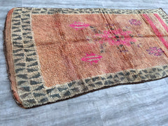 Discover the beauty of handmade Moroccan tribal rugs with this vintage boho chic carpet, a true testament to artisanal craftsmanship. Featuring traditional Berber patterns and natural wool fibers, this vintage area rug adds texture and depth to any room. The earthy tones and faded details create a lived-in, cozy aesthetic, perfect for bohemian, minimalist, or rustic interiors. Each knot tells a story, making this tribal floor decor a unique addition to your home. Whether layered in a living room, bedroom, o