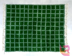 Bring warmth and style to your home with this handmade Moroccan wool rug, crafted in a traditional Berber design. Featuring a soft, plush texture, this custom boho carpet is perfect for adding a cozy touch to any room. The intricate checkered or grid pattern adds a modern yet timeless appeal, making it a versatile piece for living rooms, bedrooms, or entryways. Made from high-quality wool, this handwoven area rug is durable, comfortable, and designed to last. Available in a variety of colors, including gree