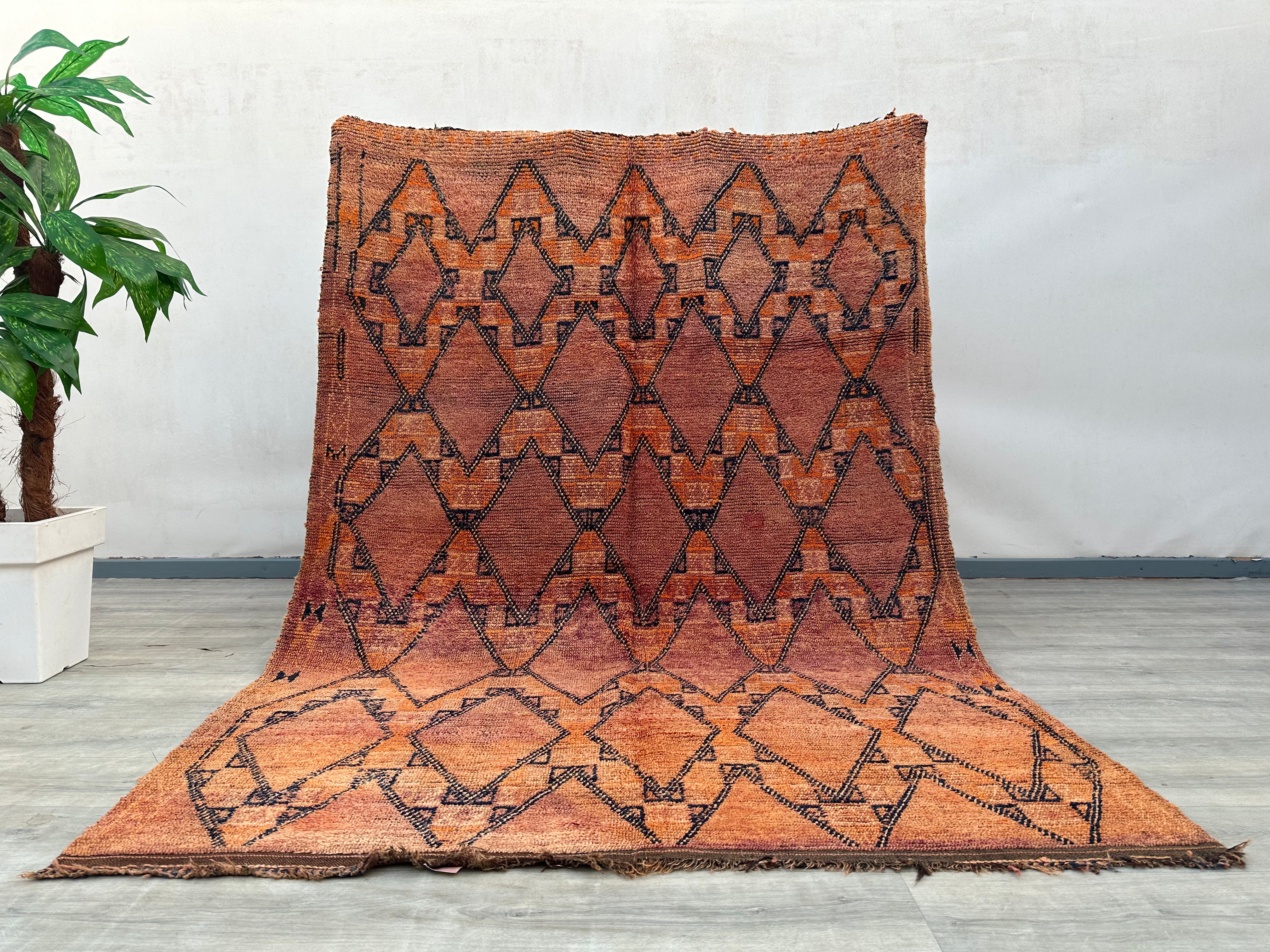 Crafted by skilled artisans, this handmade tribal wool rug features a striking checkered and diamond pattern, blending traditional weaving techniques with a contemporary aesthetic. The warm, earthy tones and intricate geometric details create a visually captivating piece that enhances any room. Made from natural wool, it offers both durability and softness underfoot, making it perfect for high-traffic areas. The faded vintage finish adds a rustic, well-worn appeal, ideal for shabby-chic, farmhouse, or eclec