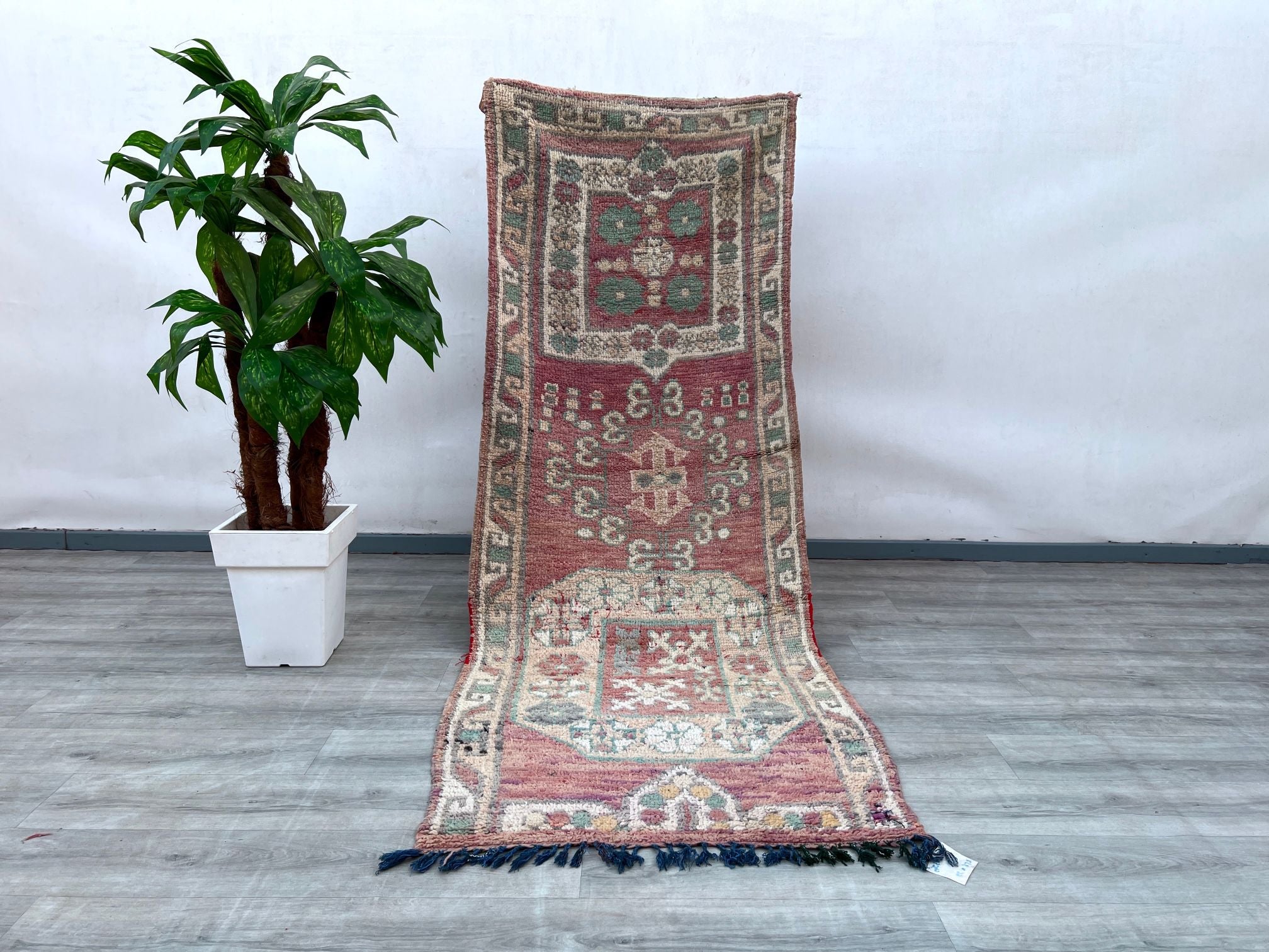 A stunning handmade vintage Turkish runner (3x9 ft / 278x82 cm) featuring tribal geometric patterns in rich red, beige, and water-green hues. Woven with high-quality wool, this Anatolian rug boasts a 70-year-old floral design with vibrant vegetable dyes. Its durable construction and distressed texture reflect authentic craftsmanship, making it perfect for high-traffic areas like hallways or kitchens. The bohemian aesthetic pairs effortlessly with modern or traditional decor. Free shipping included. A rare f