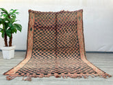 Enhance your space with this vibrant vintage checkered Moroccan rug, showcasing a beautiful blend of pink, brown, and black tribal patterns. Crafted by skilled artisans, this Berber-style rug features a mix of geometric motifs and a plush, textured feel. Ideal for layering or as a standalone statement, it adds warmth and character to bedrooms, living rooms, or dining areas. The distressed, wabi-sabi aesthetic gives it a well-loved, timeless appeal, perfect for those who appreciate handmade, one-of-a-kind de