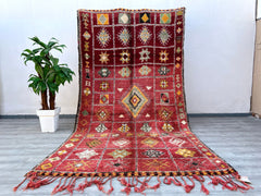 Enhance your decor with this vintage Berber rug, a handmade Moroccan wool carpet featuring rich textures and faded tribal motifs. Measuring 6x12 ft, this Boujad-style rug is crafted using traditional techniques, offering a soft, durable, and timeless addition to your home. The bohemian-inspired design blends seamlessly with modern, farmhouse, or global decor styles, making it a versatile choice for living areas, dining rooms, or entryways. Each rug tells a story through its organic imperfections and natural