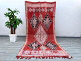 Bring timeless beauty into your home with this vintage Moroccan Berber rug, a 5x11 ft masterpiece woven by skilled artisans. The antique Boujaad design showcases rich reds, faded pinks, and tribal motifs, embodying centuries-old Berber traditions. Made from 100% natural wool, this hand-knotted carpet is both durable and luxuriously soft, ideal for high-traffic areas. Its distressed vintage look adds rustic charm, while the neutral and warm tones complement modern, bohemian, or eclectic decor. Perfect as a l