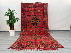 Elevate your home with this handmade vintage Moroccan rug, a 6x12 wool area rug featuring authentic Boujad tribal designs. Woven by skilled Berber artisans, this old Moroccan wool carpet boasts a plush, high-pile texture and a faded, antique aesthetic for a lived-in, bohemian feel. The neutral and warm tones blend seamlessly with various decor styles, from rustic farmhouse to eclectic global-inspired interiors. Each rug is one-of-a-kind, with slight variations in pattern and dye, ensuring a truly unique vin