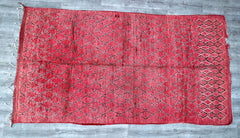 Transform your hallway or kitchen with this vintage Moroccan runner rug, a handwoven tribal piece featuring intricate patterns and a vibrant color palette. Made from natural wool, this bohemian rug is both durable and soft, perfect for high-traffic areas. The traditional Berber motifs add an exotic touch, while the neutral and earthy tones complement various decor styles—from farmhouse to mid-century modern. Whether used as a statement floor piece or a wall hanging, this authentic Moroccan rug brings warmth