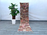 This oversized vintage Moroccan rug (6’9” x 11’4”) is a handwoven masterpiece, showcasing bold tribal motifs and a vibrant color palette. Crafted from 100% wool, it offers durability and a luxuriously soft texture. The rug’s faded, distressed look adds rustic charm, making it a statement piece for living areas, dining rooms, or studios. Its versatile design complements bohemian, farmhouse, and mid-century modern interiors. Ethically handmade by Berber weavers, this rug is not just decor but a piece of Moroc