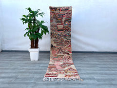 This oversized vintage Moroccan rug (6’9” x 11’4”) is a handwoven masterpiece, showcasing bold tribal motifs and a vibrant color palette. Crafted from 100% wool, it offers durability and a luxuriously soft texture. The rug’s faded, distressed look adds rustic charm, making it a statement piece for living areas, dining rooms, or studios. Its versatile design complements bohemian, farmhouse, and mid-century modern interiors. Ethically handmade by Berber weavers, this rug is not just decor but a piece of Moroc