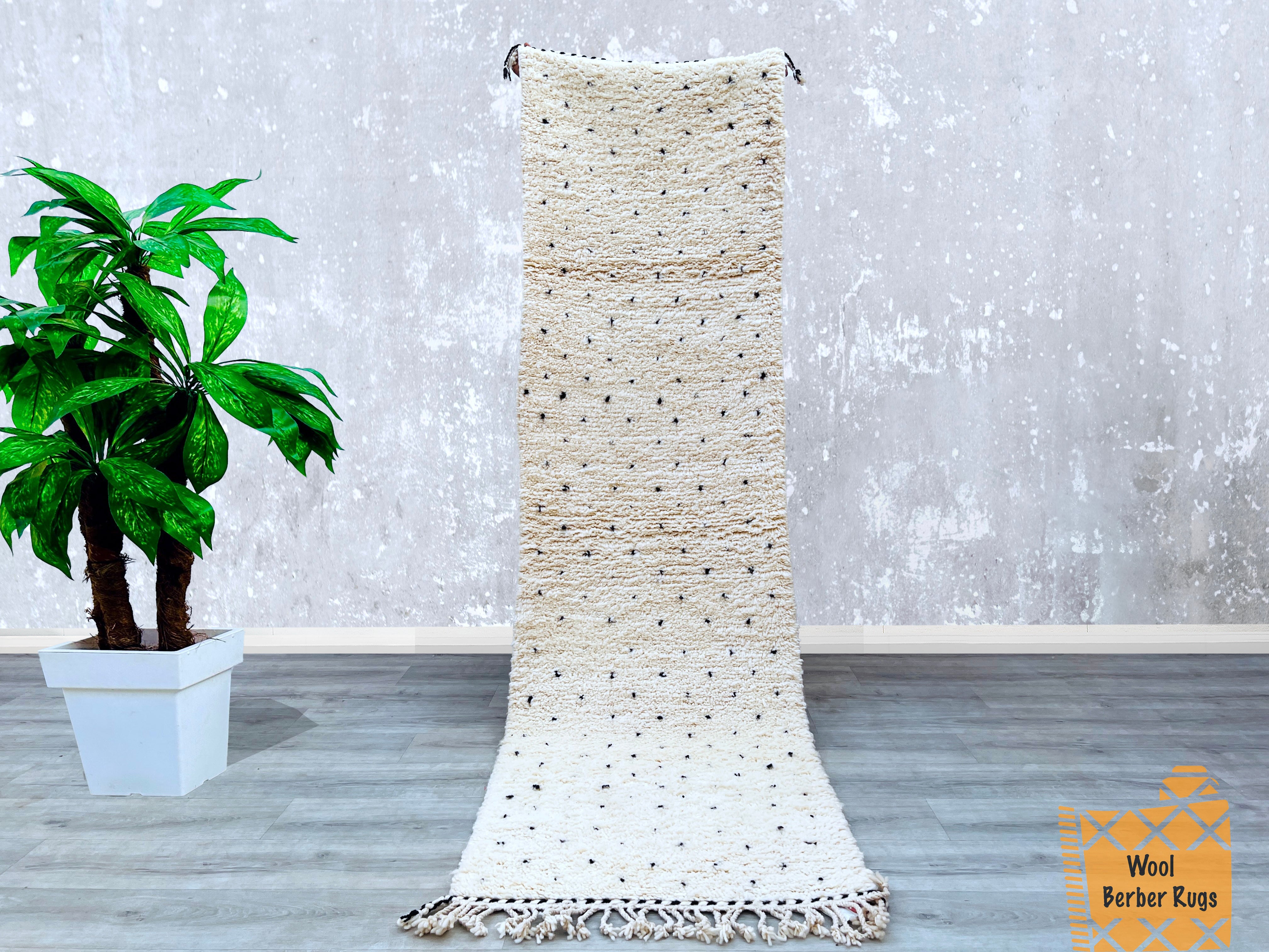 Bring Moroccan charm into your home with this hand-knotted Beni Ourain rug, a handmade Berber carpet featuring intricate tribal patterns. Woven from premium lamb’s wool, this soft, fluffy rug (sizes like 3x9, 4x8, or 5x8 FT) is perfect for living rooms, bedrooms, or hallways. The neutral black-and-white design blends seamlessly with Scandinavian, bohemian, or farmhouse styles. Each rug is one-of-a-kind, crafted using centuries-old techniques by Moroccan artisans. Whether used as a statement piece or a cozy