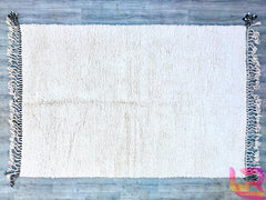 Enhance your space with this premium Beni Ourain Moroccan rug, a handwoven masterpiece from the Atlas Mountains. This 8.5 FT x 11.7 FT (8x12) rug is crafted from natural, undyed wool, offering a cloud-like softness underfoot. The minimalist black-and-white tribal patterns add sophistication to any room—ideal for Scandinavian, boho-chic, or eclectic interiors. Each rug is individually hand-knotted, ensuring a one-of-a-kind heirloom piece. The thick, fluffy pile provides insulation and comfort, making it perf